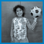 girl smiling with soccer ball